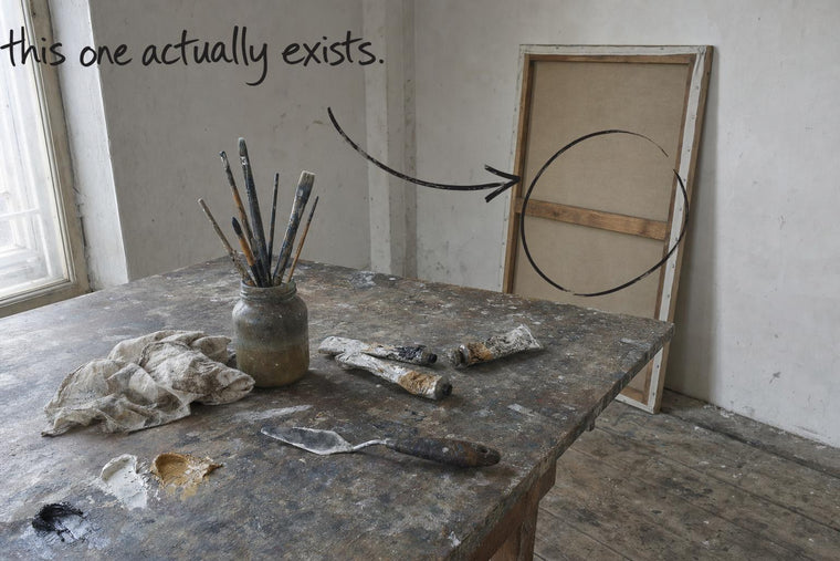 A paint-stained studio table with oil paint, brushes in turpentine and a canvas standing edge-on behind it, the canvas at the back circled in open black marker, an arrow from the handwritten words this one actually exists, by Willem van der Krieken