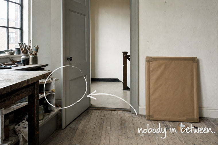 An open studio door with a flat parcel wrapped in brown paper leaning beside it, the open doorway circled in open black marker, an arrow from the handwritten words nobody in between, by Willem van der Krieken