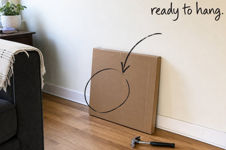 A flat cardboard shipping box leaning against a wall, still taped shut, the wrapped parcel circled in open black marker, an arrow from the handwritten words ready to hang, by Willem van der Krieken