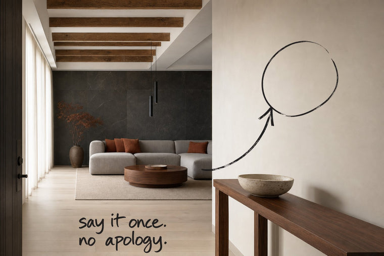 An entrance hall with a dark stone wall and a slim console table, the wall beside the console circled in open black marker, an arrow from the handwritten words say it once, no apology, by Willem van der Krieken
