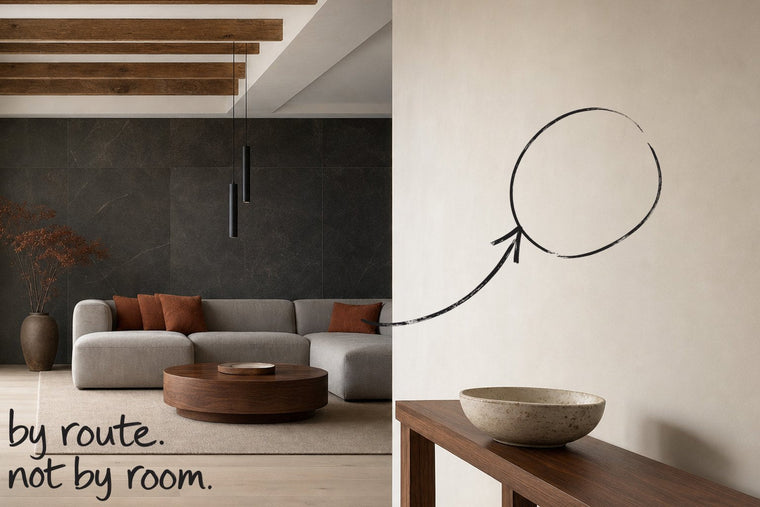 An entrance hall with a dark stone wall and a slim console table, the wall on the route to the table circled in open black marker, an arrow from the handwritten words by route, not by room, by Willem van der Krieken