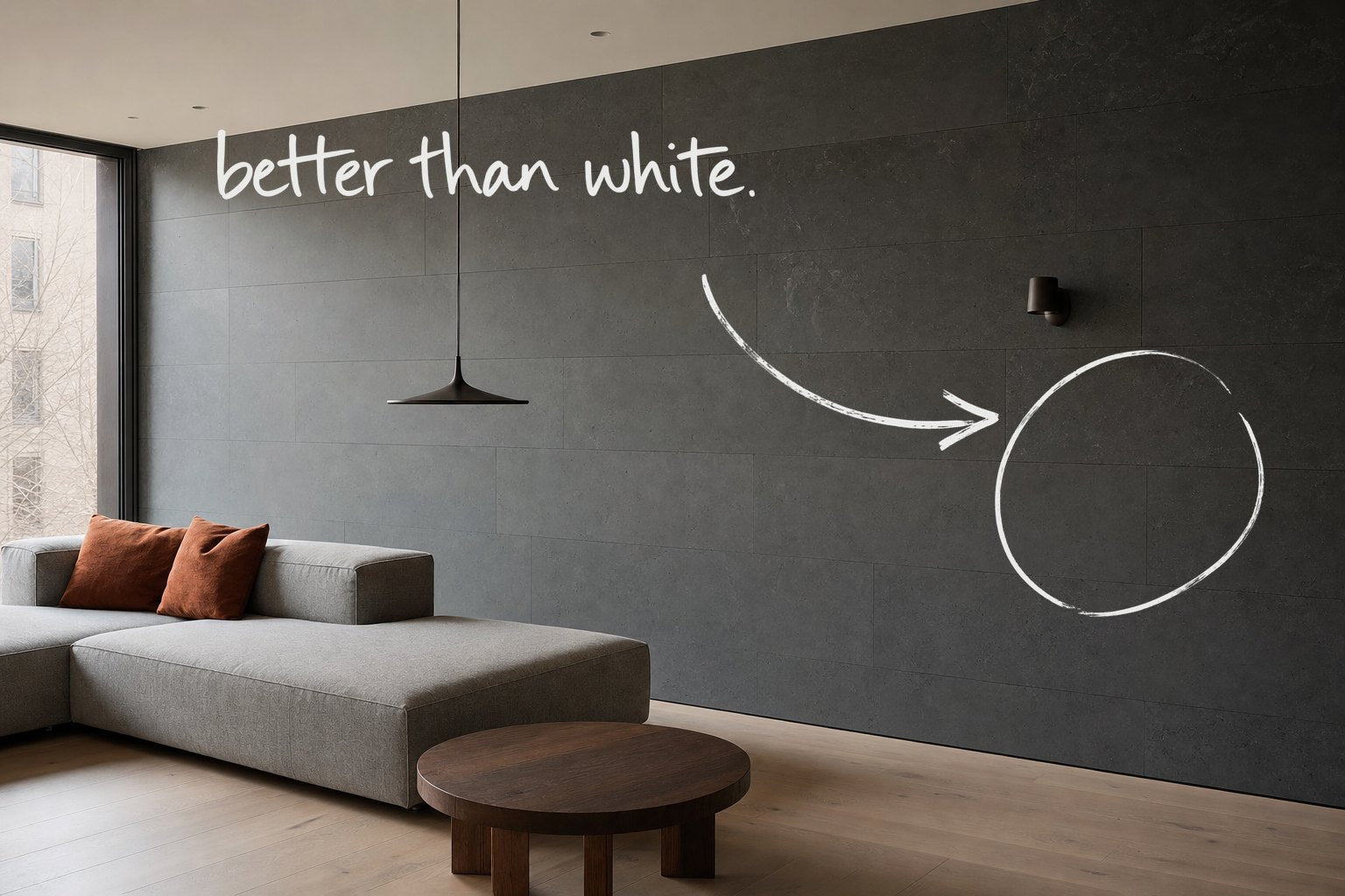 A living room with a dark honed stone wall along its length and a stone grey sofa, the dark stone wall circled in open black marker, an arrow from the handwritten words better than white, by Willem van der Krieken